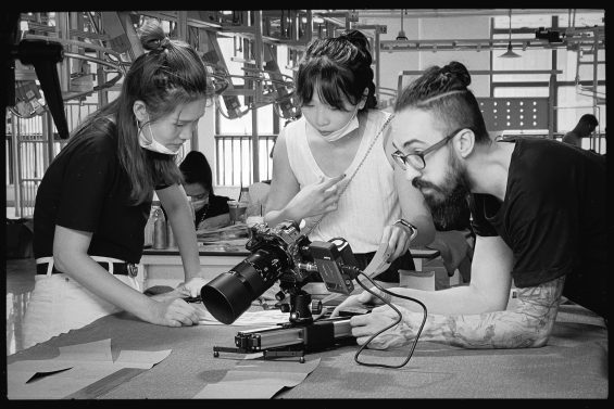 Hitomi (Director) and J (DOP) talk with Miu (Creative director of 水云间）on a factory photo shoot