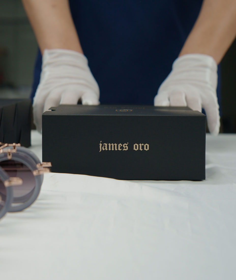 Cinematic shot of the quality control and inspection of the package for James Oro glasses in a factory inspection.